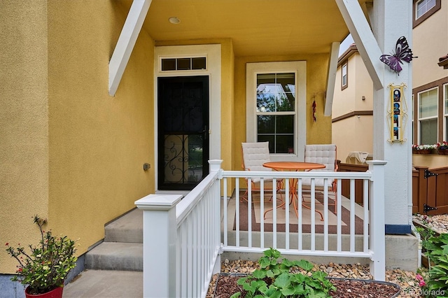 9311 E 5th Ave, Denver, CO 80230 - view of exterior entry featuring a porch and stucco siding