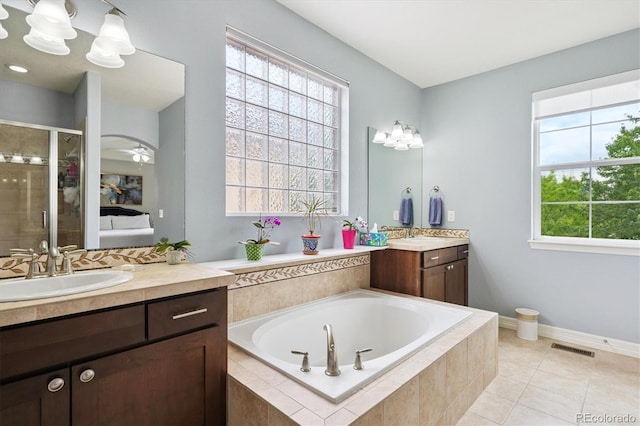 9311 E 5th Ave, Denver, CO 80230 - ensuite bathroom featuring two vanities, a bath, a stall shower, and tile patterned flooring