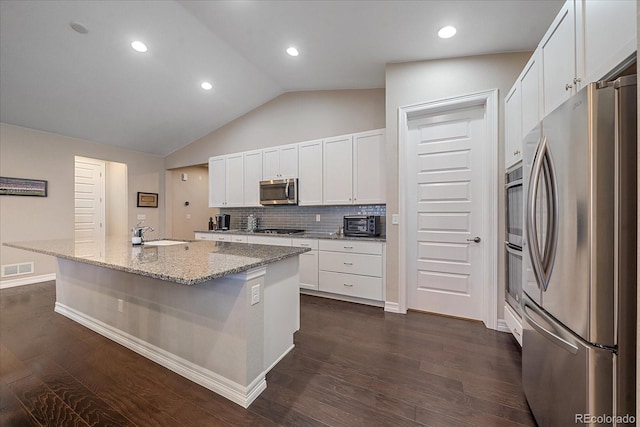 kitchen featuring white cabinets, appliances with stainless steel finishes, dark hardwood / wood-style flooring, and a center island with sink