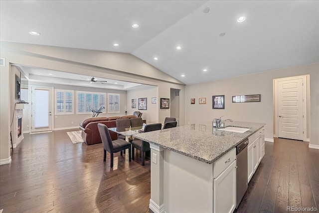 kitchen with white cabinetry, sink, dark hardwood / wood-style flooring, vaulted ceiling, and a kitchen island with sink