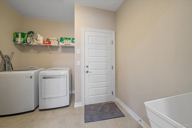 washroom featuring washer and dryer and light tile patterned floors