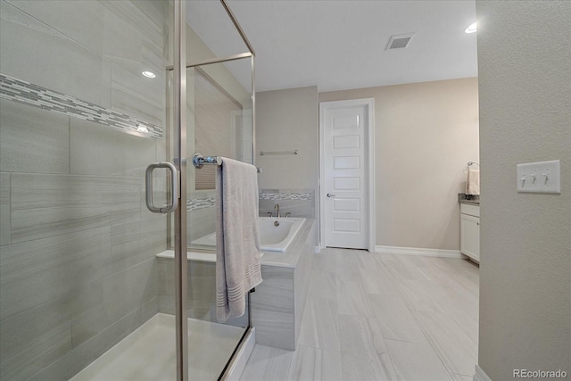 bathroom featuring shower with separate bathtub and vanity