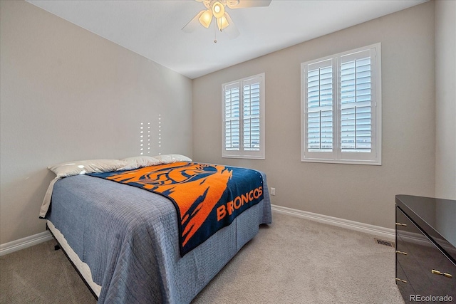 bedroom with ceiling fan and light colored carpet