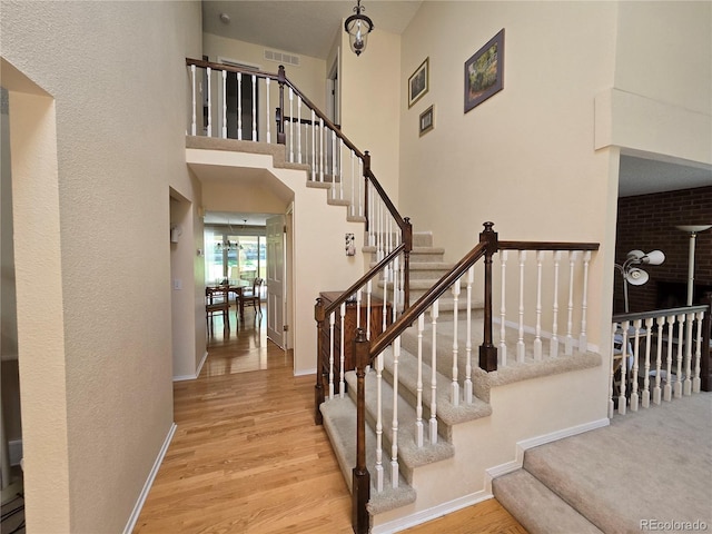7290 S Cook Cir, Centennial, CO 80122 - stairway featuring wood finished floors and a high ceiling