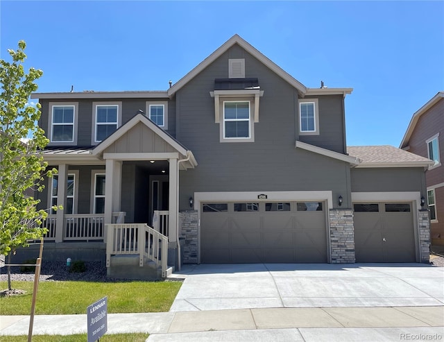 4598 Windmill Dr, Brighton, CO 80601 - view of front of house featuring concrete driveway, stone siding, an attached garage, and a porch