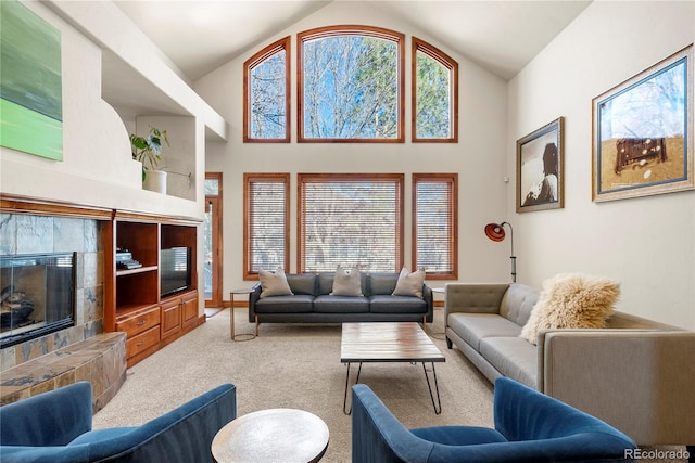 5350 S Marshall St, Littleton, CO 80123 - carpeted living room featuring a tiled fireplace, high vaulted ceiling, and baseboards