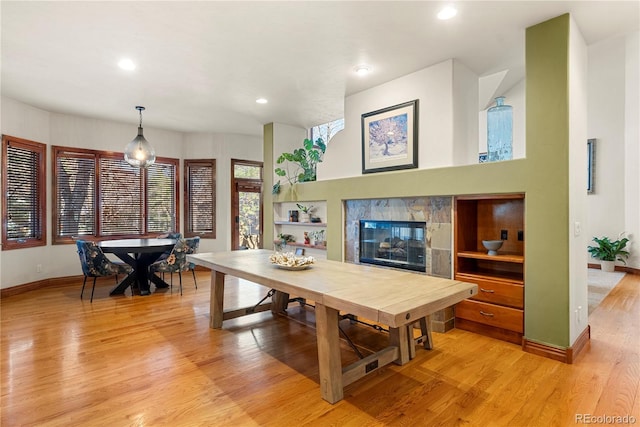 5350 S Marshall St, Littleton, CO 80123 - dining space with light wood-style flooring, baseboards, a tile fireplace, recessed lighting, and built in shelves
