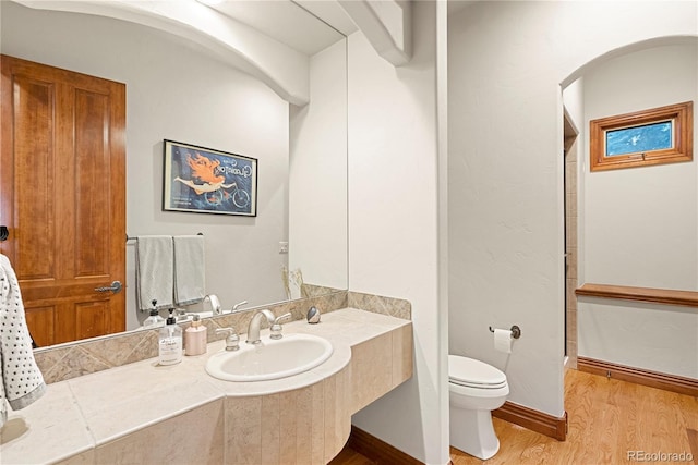 5350 S Marshall St, Littleton, CO 80123 - full bathroom with wood finished floors, toilet, and vanity
