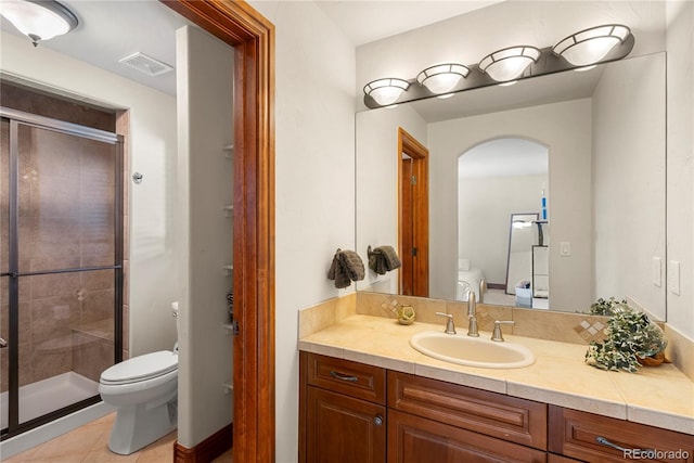 5350 S Marshall St, Littleton, CO 80123 - full bath with toilet, a stall shower, vanity, and tile patterned floors