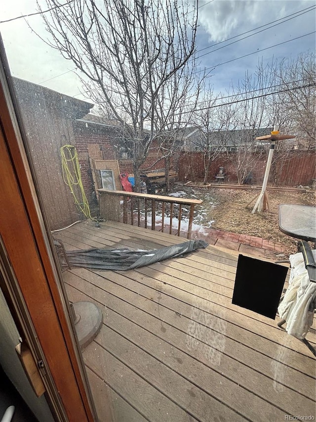 wooden terrace featuring fence