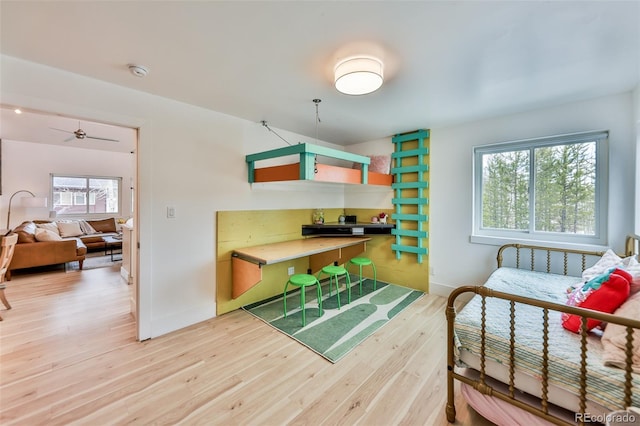 bedroom with multiple windows and wood-type flooring