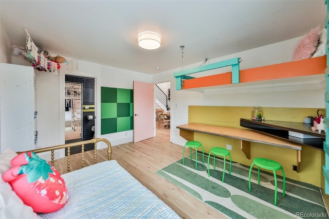 bedroom with wood-type flooring