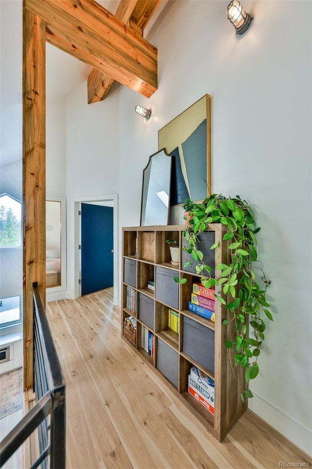 playroom with beam ceiling and hardwood / wood-style flooring