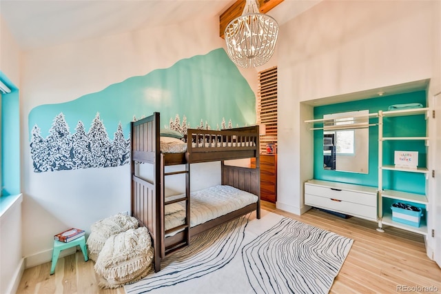 bedroom featuring hardwood / wood-style floors and a chandelier