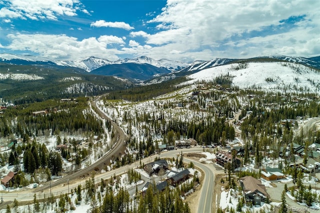 snowy aerial view with a mountain view