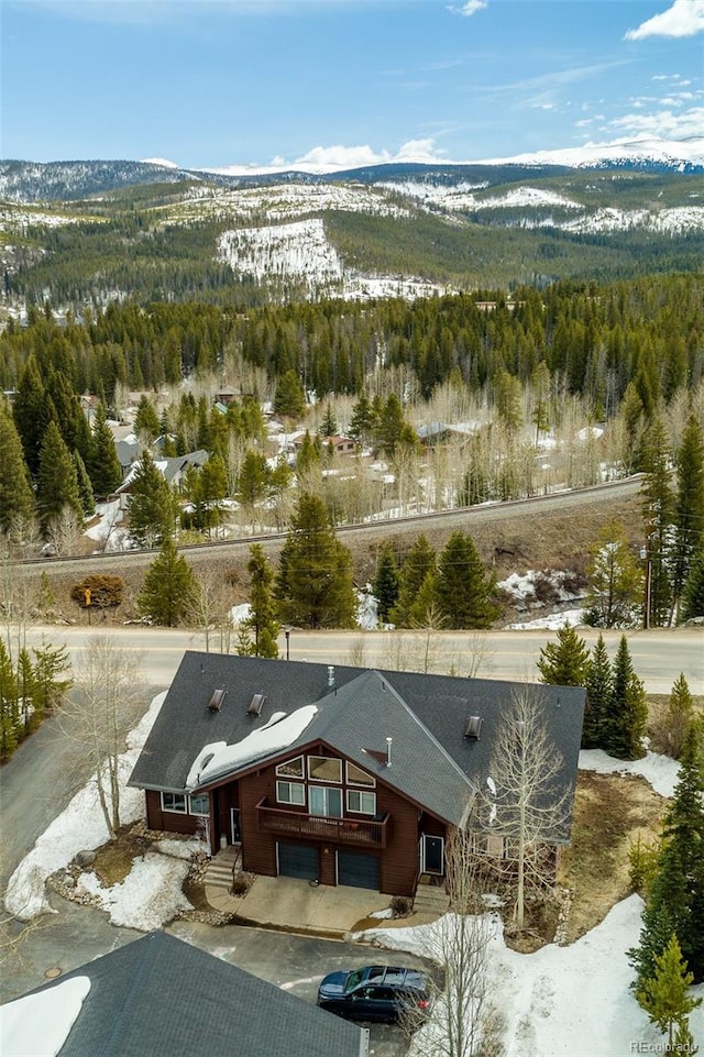 snowy aerial view featuring a mountain view