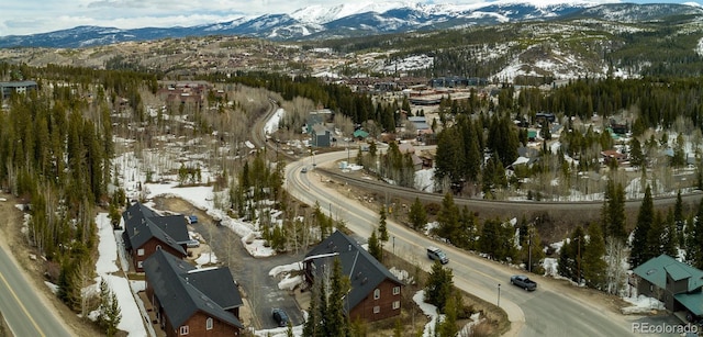 snowy aerial view with a mountain view