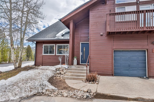 view of front of home featuring a garage and a balcony