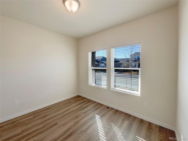 spare room with light hardwood / wood-style flooring