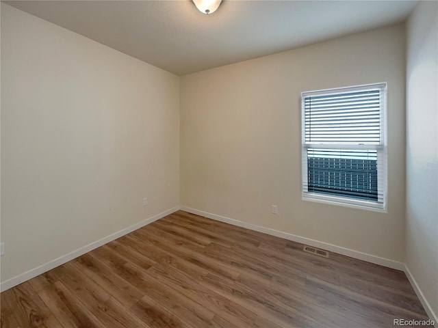 empty room with hardwood / wood-style flooring