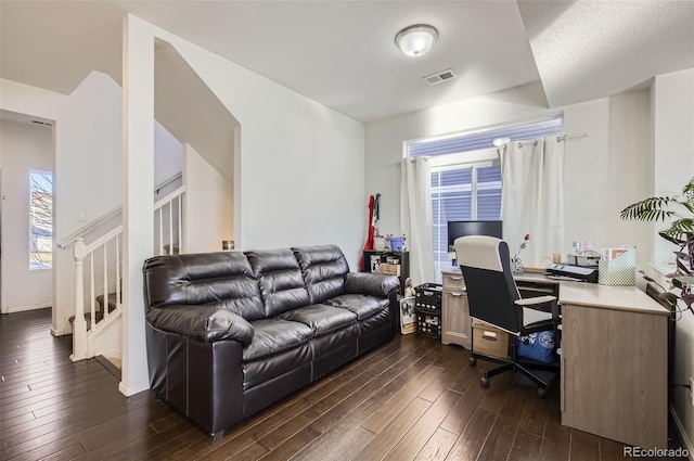 home office featuring a textured ceiling and dark hardwood / wood-style floors