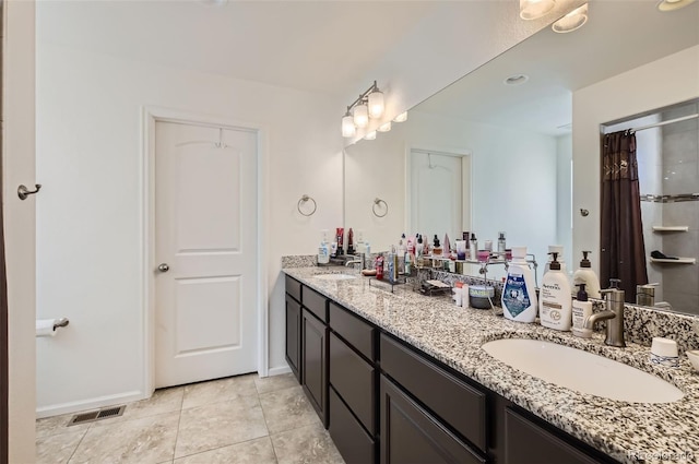 bathroom with vanity and tile patterned floors