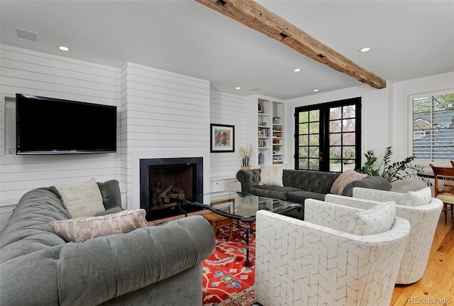 535 N High St, Denver, CO 80218 - living room featuring light wood-type flooring, recessed lighting, beamed ceiling, and a large fireplace