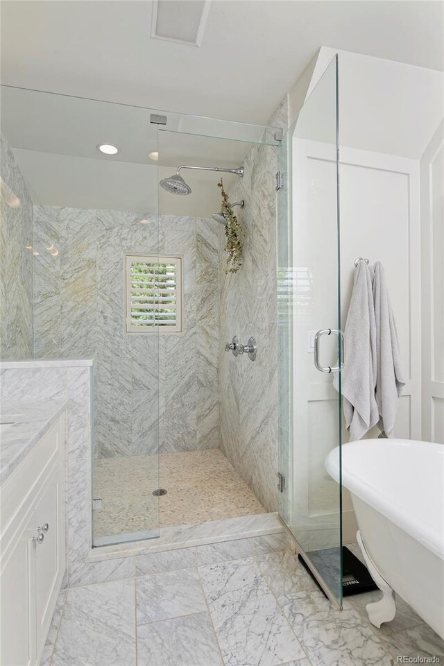 535 N High St, Denver, CO 80218 - full bathroom with a shower stall, a freestanding bath, vanity, marble finish flooring, and recessed lighting