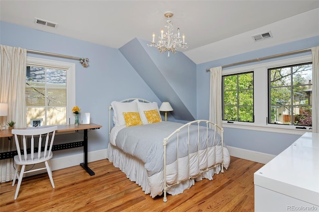 535 N High St, Denver, CO 80218 - bedroom with multiple windows, baseboards, lofted ceiling, light wood-type flooring, and a chandelier