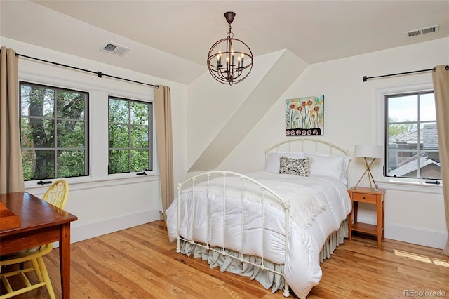 535 N High St, Denver, CO 80218 - bedroom with baseboards, light wood-type flooring, a chandelier, and vaulted ceiling