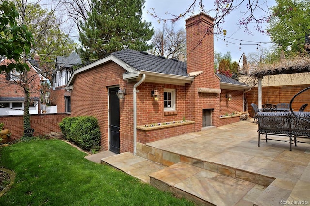 535 N High St, Denver, CO 80218 - rear view of house with brick siding, a chimney, a patio, and a fireplace