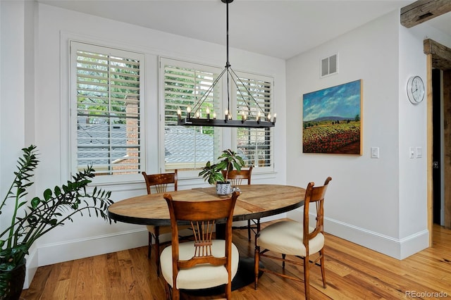 535 N High St, Denver, CO 80218 - dining room with baseboards, a chandelier, and healthy amount of natural light