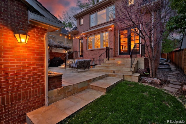 535 N High St, Denver, CO 80218 - rear view of property featuring brick siding, fence, and a patio