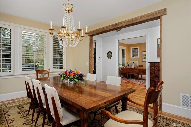 535 N High St, Denver, CO 80218 - dining room with baseboards, light wood-type flooring, and a chandelier