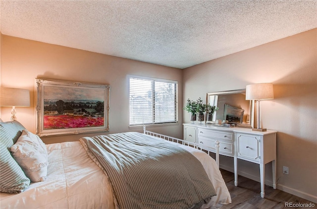 bedroom featuring a textured ceiling and hardwood / wood-style floors