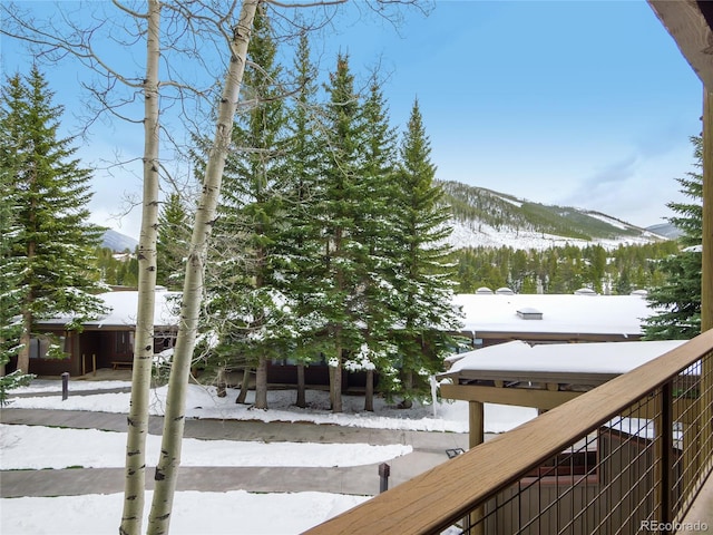 snow covered deck featuring a mountain view