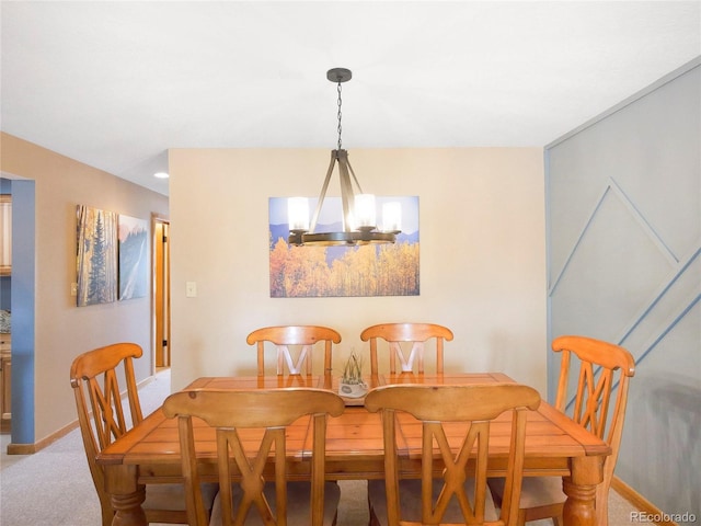 dining area featuring carpet flooring and an inviting chandelier