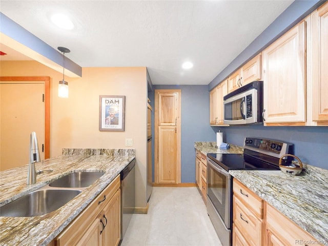 kitchen with light stone countertops, sink, hanging light fixtures, stainless steel appliances, and light brown cabinetry