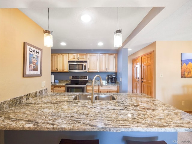 kitchen with pendant lighting, sink, stainless steel appliances, and light brown cabinets