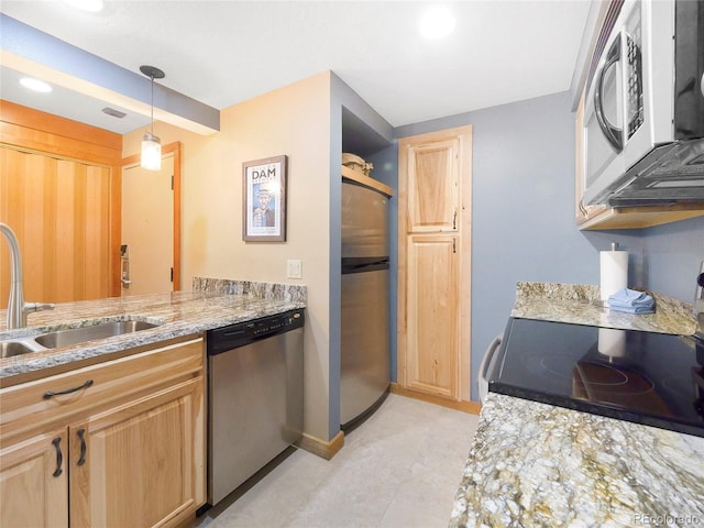 kitchen featuring light brown cabinetry, pendant lighting, sink, and stainless steel appliances