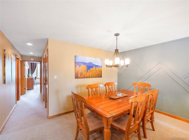 carpeted dining space with a chandelier