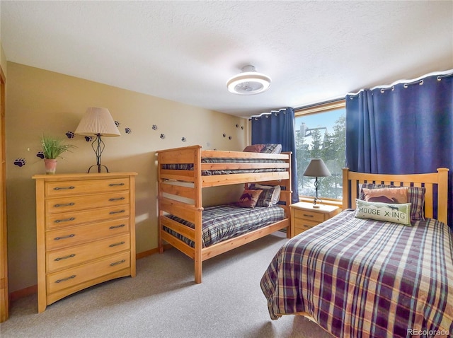 bedroom featuring carpet flooring and a textured ceiling