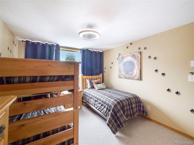 bedroom with carpet and a textured ceiling