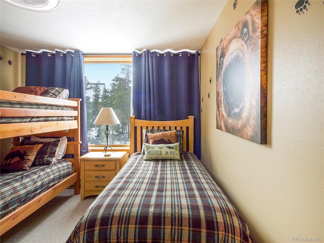 bedroom with carpet flooring and multiple windows