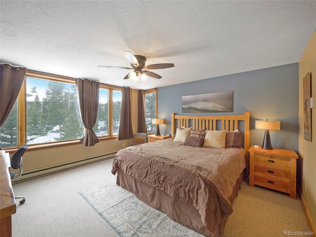 carpeted bedroom featuring a textured ceiling, ceiling fan, and a baseboard heating unit