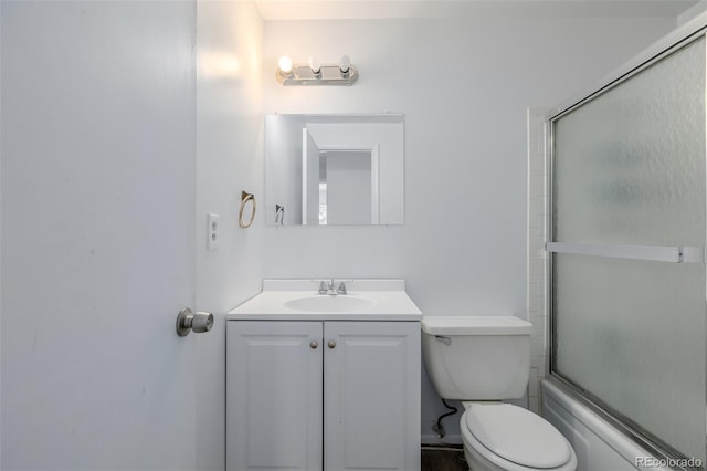 full bathroom with bath / shower combo with glass door, vanity, and toilet