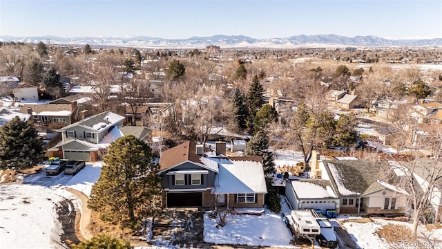 snowy aerial view featuring a mountain view