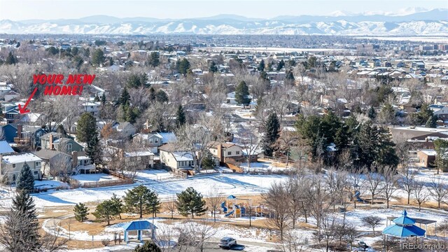 snowy aerial view with a mountain view