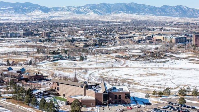 snowy aerial view with a mountain view