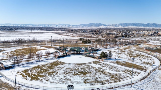 snowy aerial view featuring a mountain view